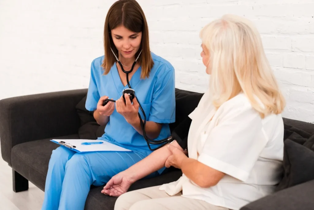 Healthcare professional checking a woman’s blood pressure during a primary care appointment