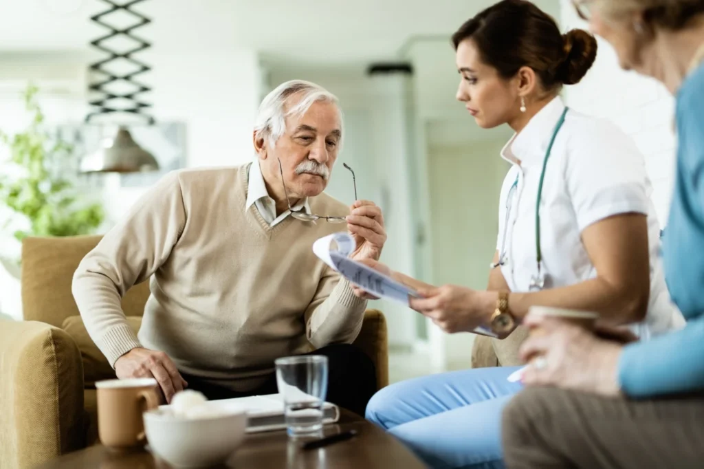 Healthcare professional reviewing health information with an older man